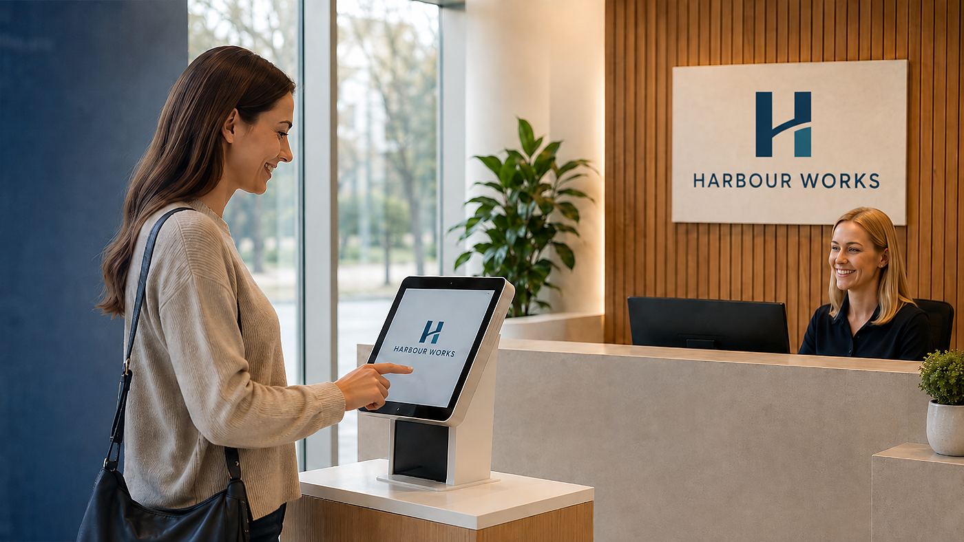 Visitor signing in on a digital kiosk at a workplace reception