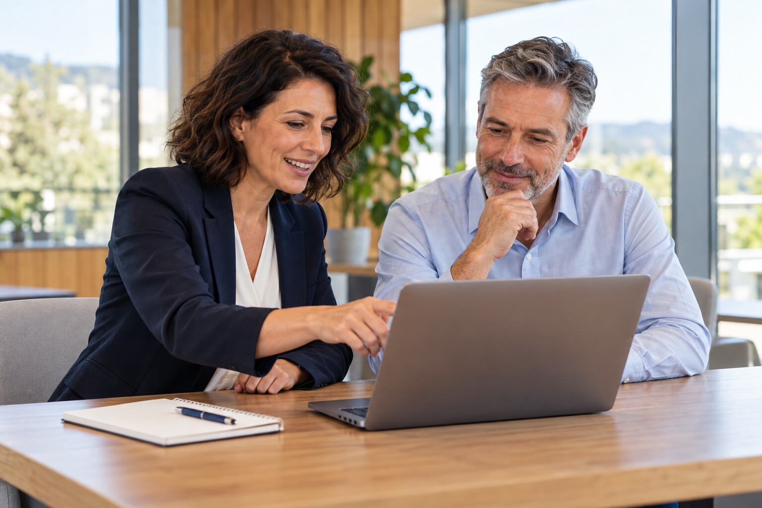 Onboarding adviser and business customer reviewing account setup on a laptop